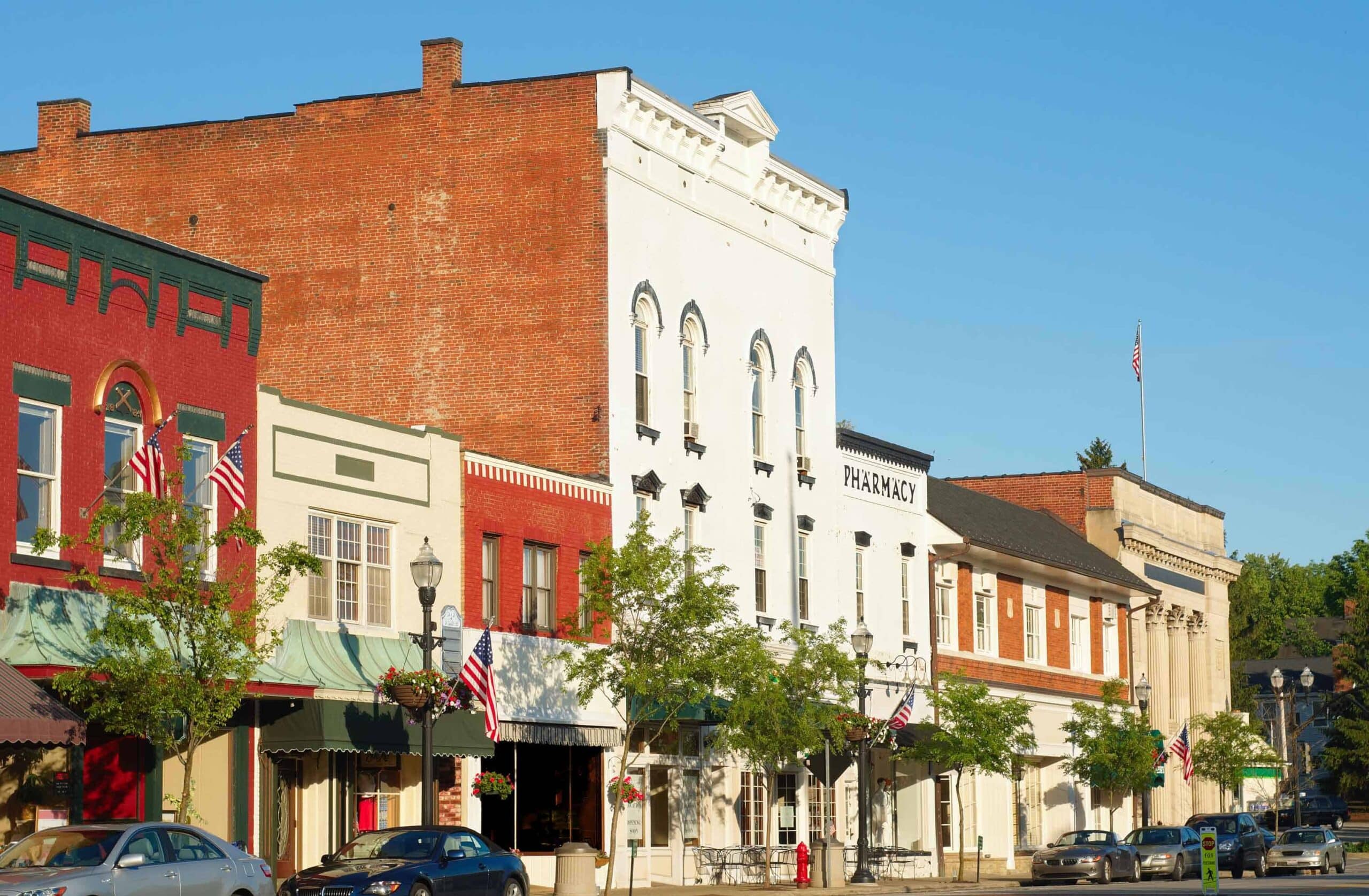Historic downtown brick buildings with storefronts and American flags