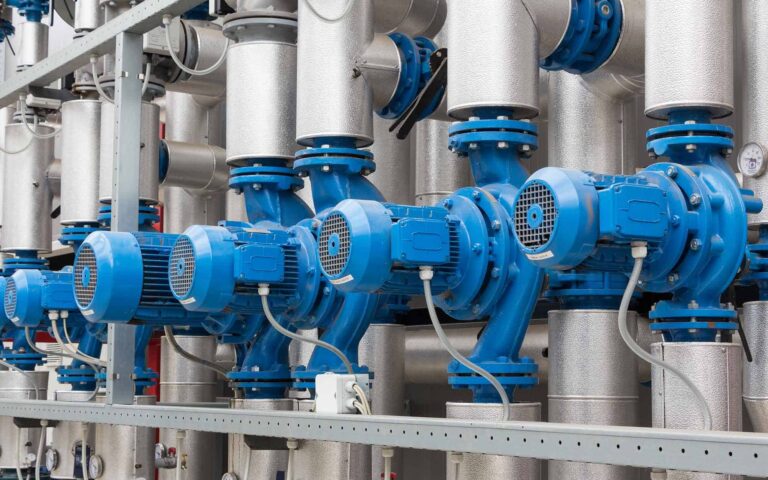 Industrial climate control pump system with blue motors and silver piping