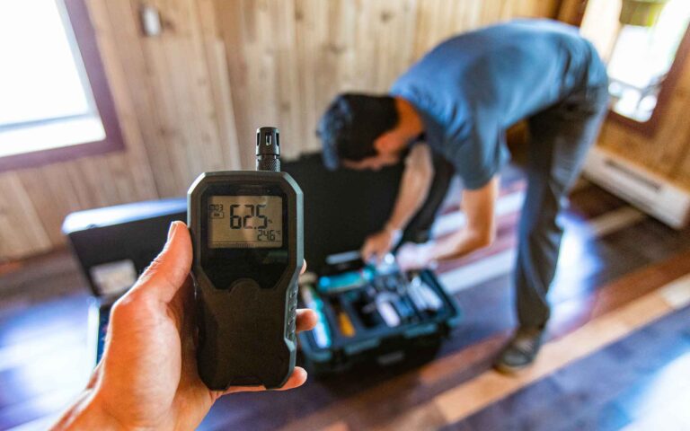 Moisture meter reading 62.5% during home inspection assessment