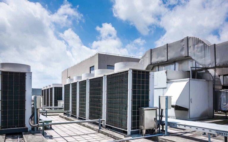 Commercial HVAC units with heat exchangers on building rooftop