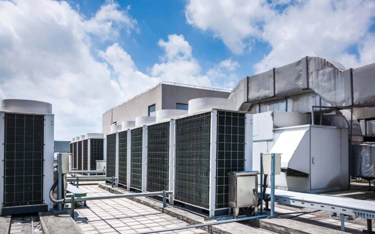 Commercial HVAC rooftop unit with condenser coils and ductwork installation
