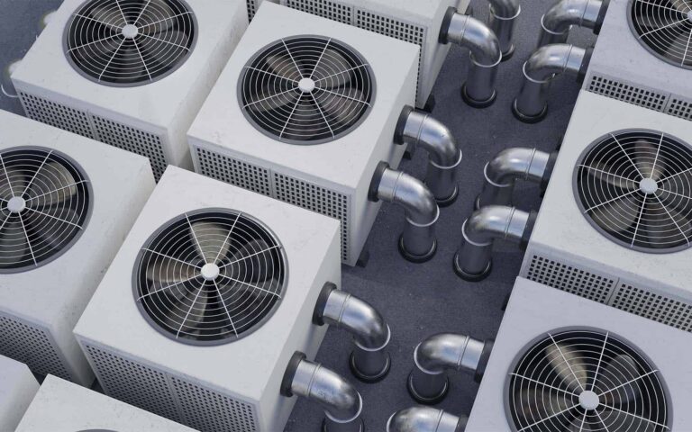 Multiple HVAC outdoor units with ventilation fans and ductwork viewed from above