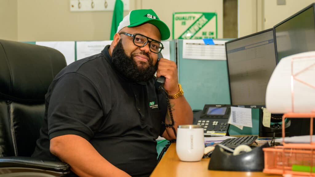 Service Unlimited team member at desk in office environment