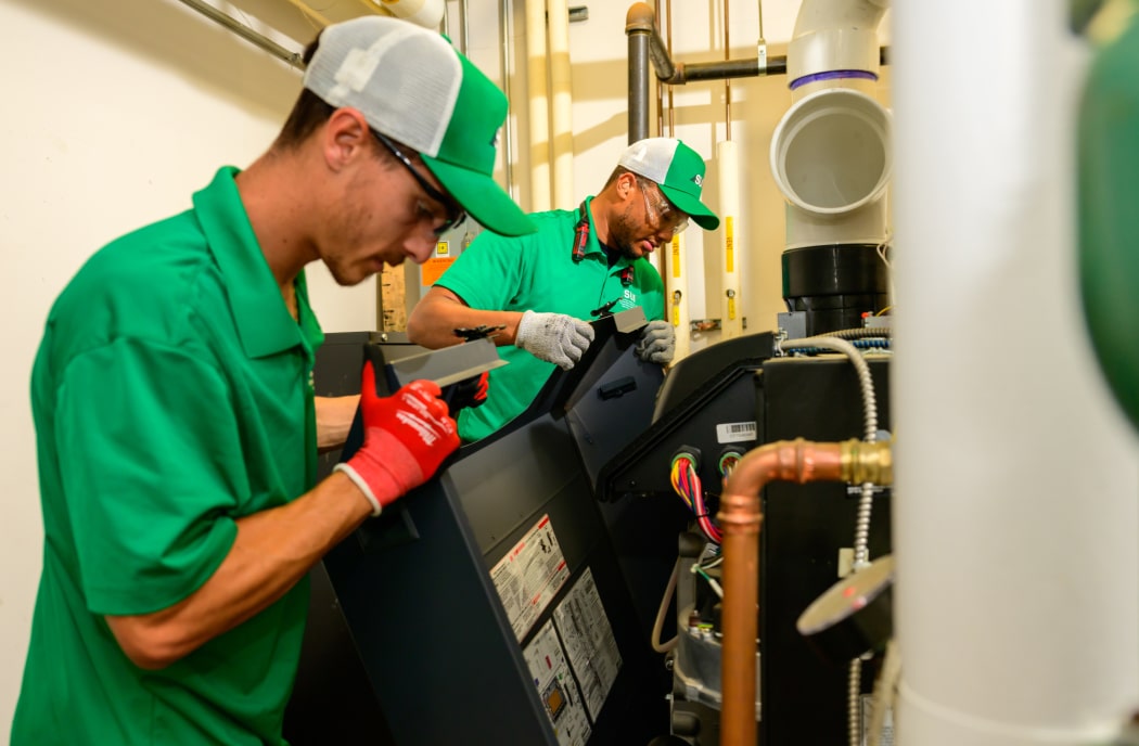 HVAC technicians performing commercial equipment maintenance and repair
