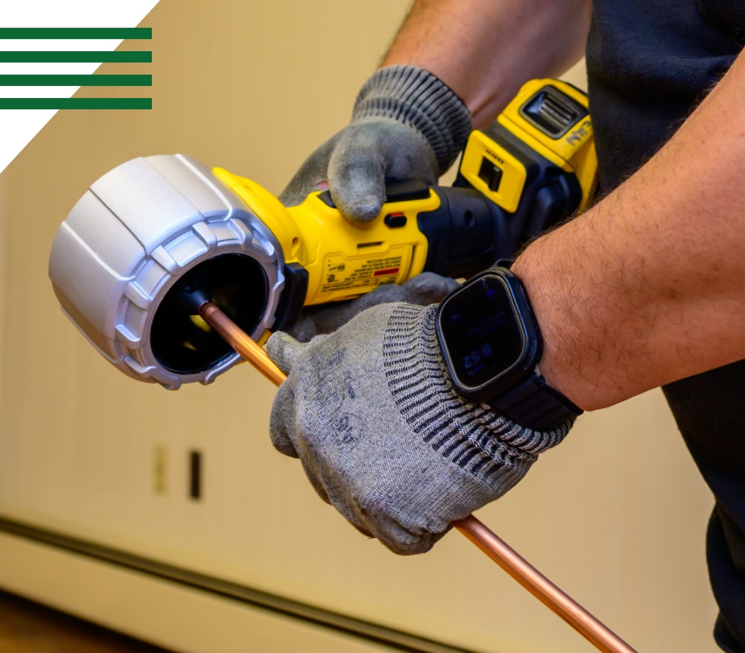 Technician in work gloves installing HVAC system component with professional tools