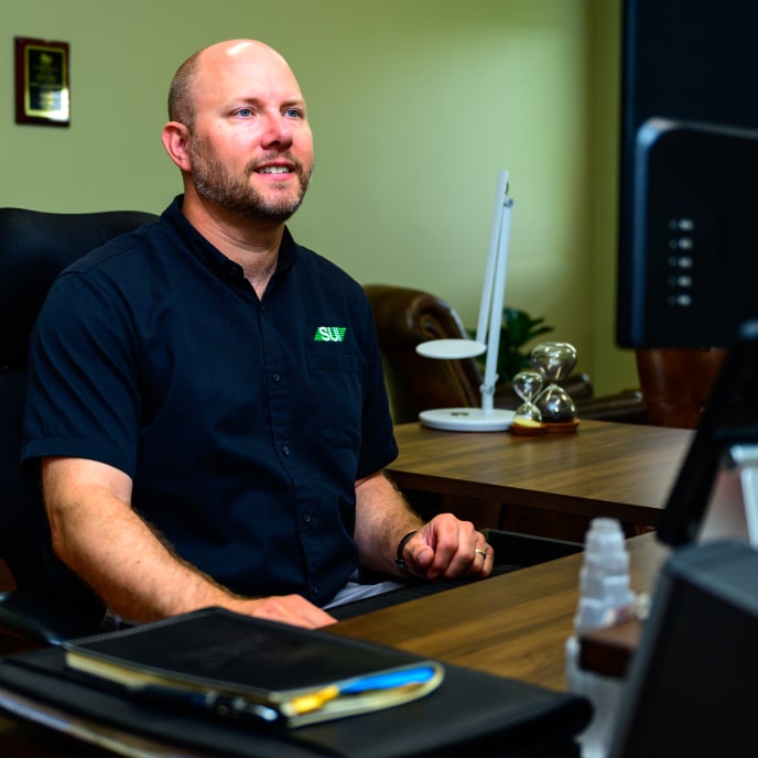 Service Unlimited technician at desk during client consultation