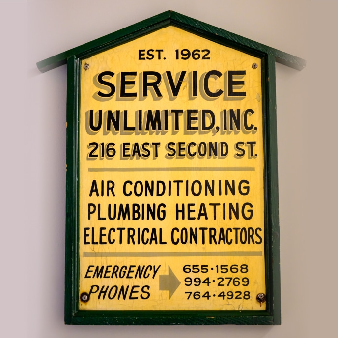 Service Unlimited vintage yellow and green sign established 1962