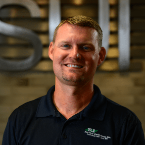 Service Unlimited team member in black SUI polo shirt