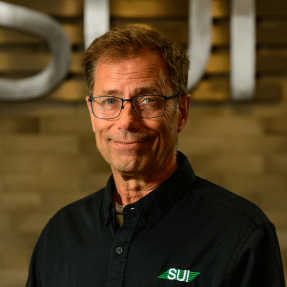Service Unlimited team member in black SUI polo shirt