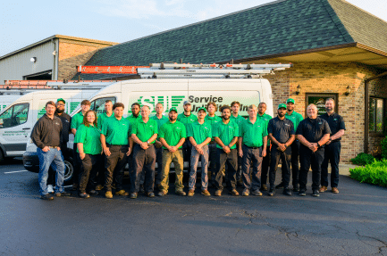 Service Unlimited team members standing together outside company facility