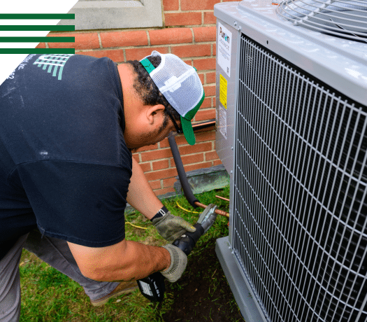 Technician inspecting outdoor HVAC unit for preventive maintenance