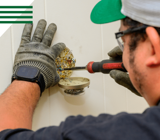 HVAC technician inspecting system component during retrofit evaluation