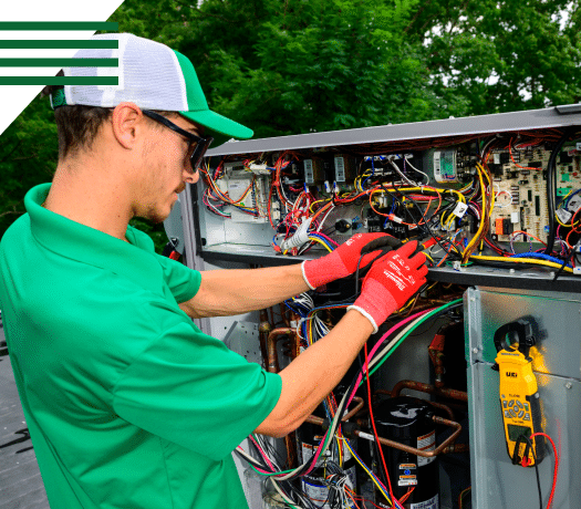 HVAC technician diagnosing equipment during emergency repair service